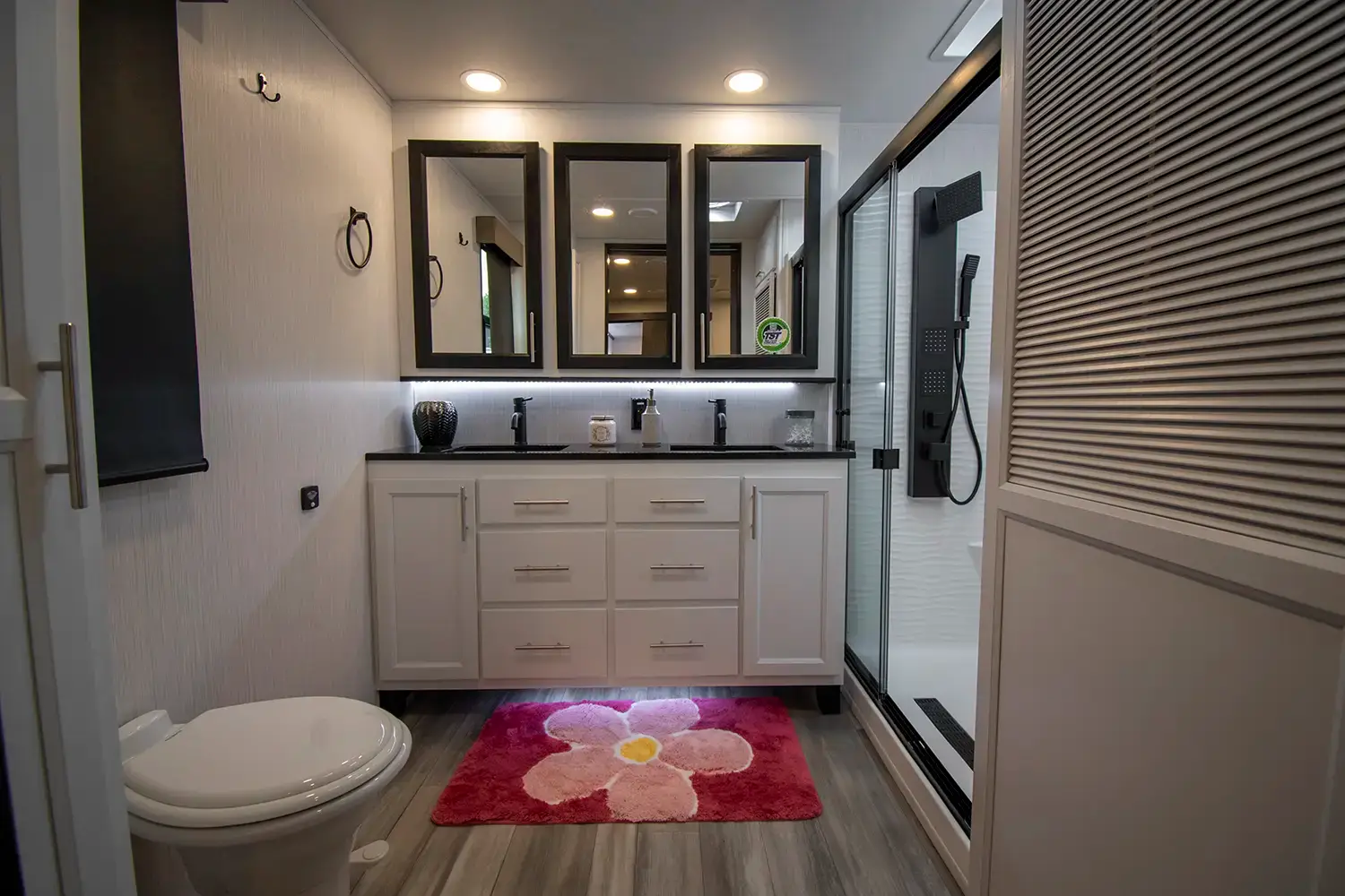 The spacious bathroom with dual vanity facing rear